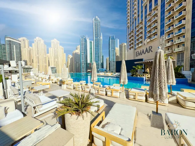Pool with sun loungers and the Dubai Marina skyline
